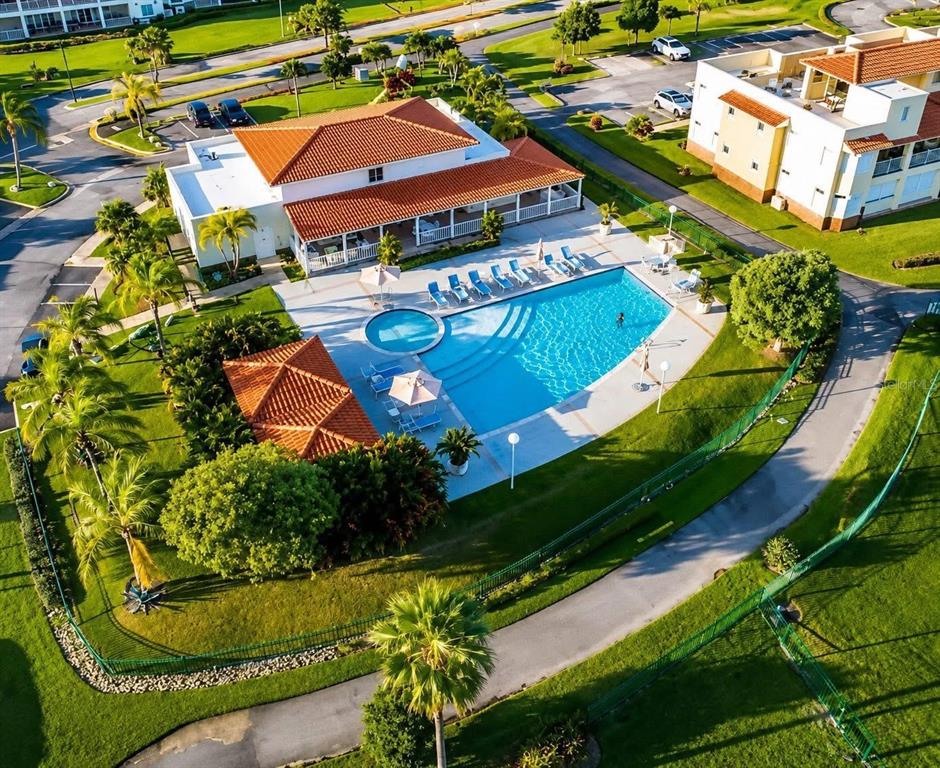 An aerial view of a community clubhouse with a swimming pool and surrounding landscaping — Palmas Drive COND. HARBOUR LAKES UNIT 26, HUMACAO, PR