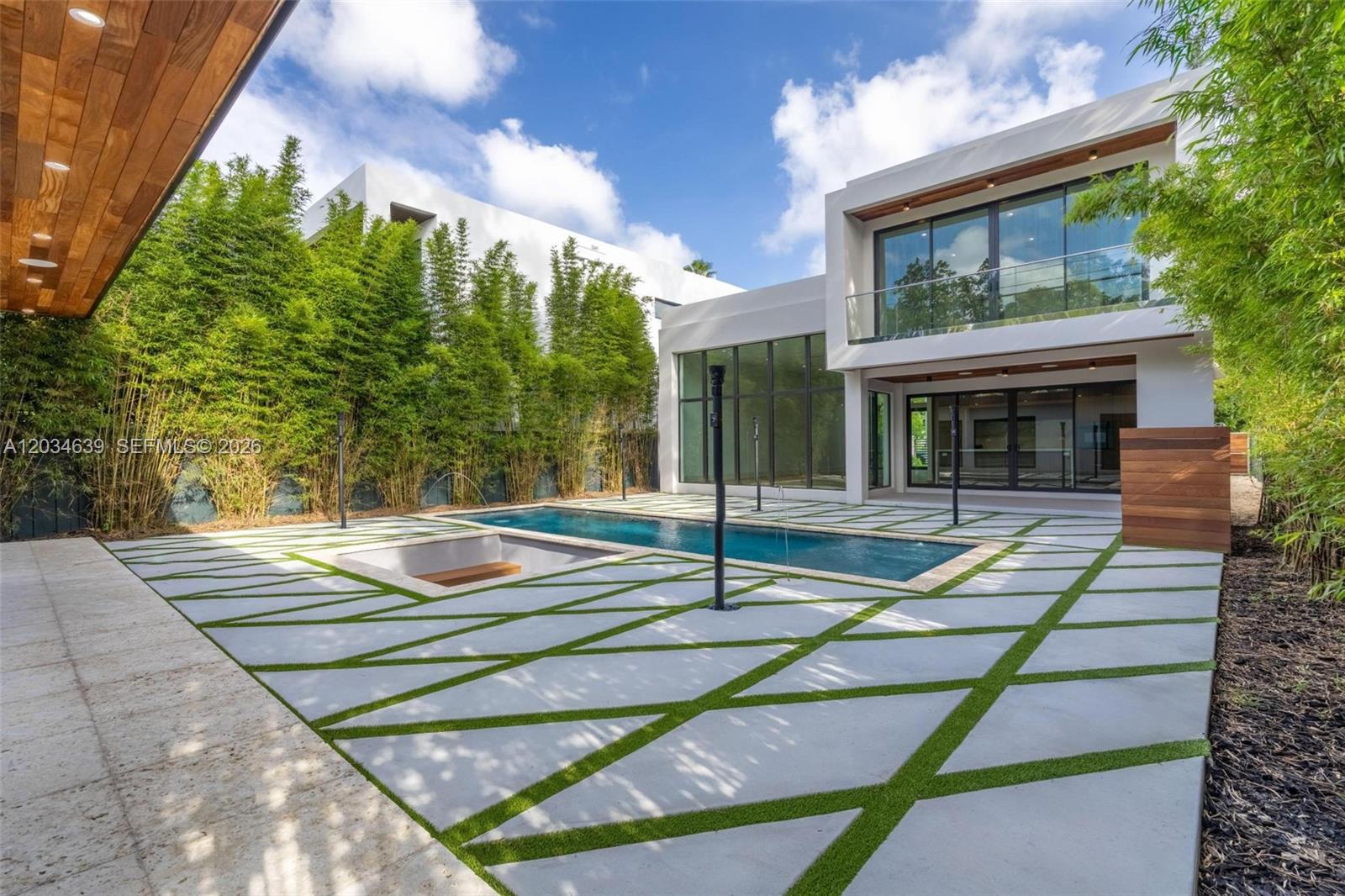 A modern house features a swimming pool, a sunken seating area, and geometric patio pavers — 43 NW 42nd St, Miami FL 33127, MIAMI, FL