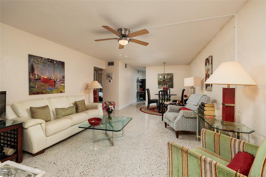 A living and dining area with terrazzo floors, a ceiling fan, and neutral walls — 4143 56TH STREET N UNIT 903, KENNETH CITY, FL