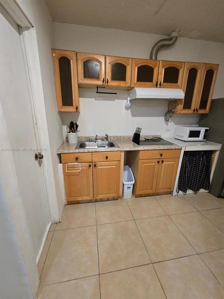 This kitchen features light wood cabinets, a stainless steel sink, and a tiled floor — 4863 SW 148th Ct # 1, Miami FL 33185, MIAMI, FL