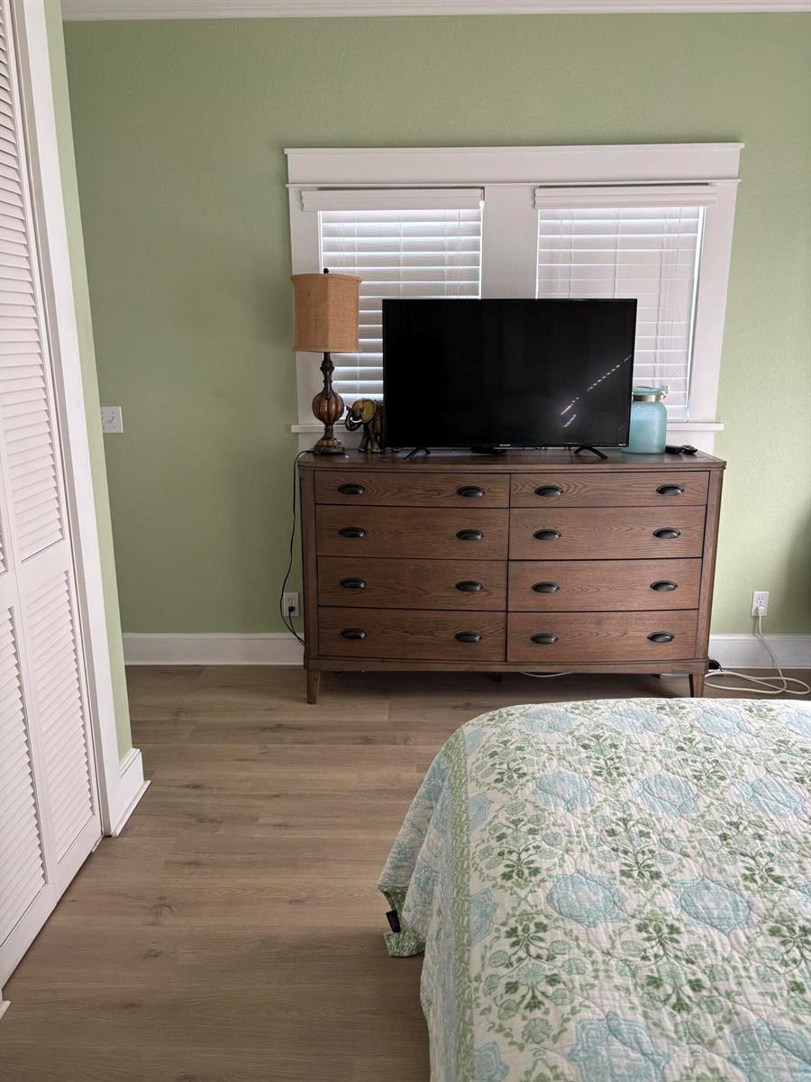 A bedroom features a wooden dresser with a television, a lamp, and light green walls — 808 Kanuga Drive, West Palm Beach FL 33401, WEST PALM BEACH, FL