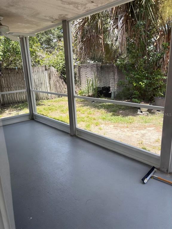 A screened-in porch with a gray painted floor overlooks a fenced backyard with vegetation — 1948 CRANBERRY ISLES WAY, APOPKA, FL