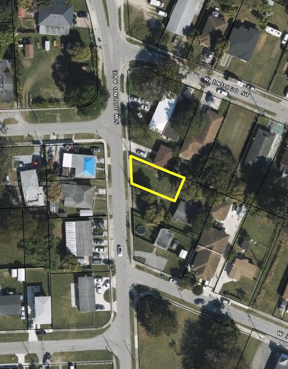 This is an aerial map showing a vacant lot highlighted in yellow along a residential street — 17709 SW 102nd Ave, Miami FL 33157, MIAMI, FL