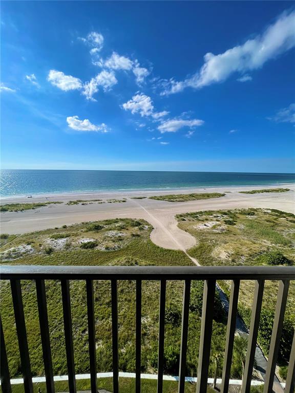 A view of a sandy beach and ocean from a balcony with a metal railing — 1290 GULF BOULEVARD UNIT 1003, CLEARWATER BEACH, FL
