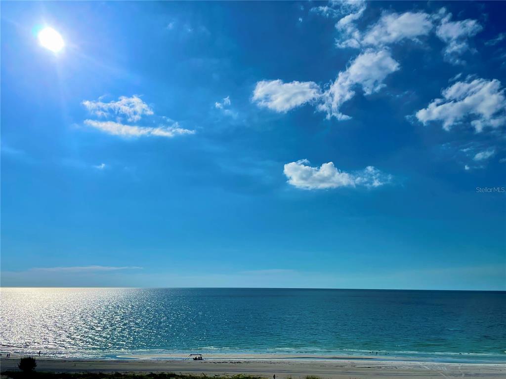 A view of a sandy beach and the ocean under a bright, sunny sky — 1290 GULF BOULEVARD UNIT 1003, CLEARWATER BEACH, FL