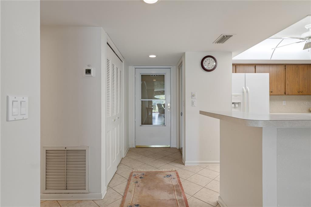 A tiled entryway leads to a glass-paneled door with a view of a patio — 3 CYPRESS RUN UNIT 33C, HOMOSASSA, FL