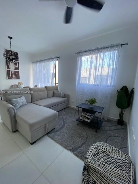 A living room features a light gray sectional sofa, a black coffee table, and sheer curtains — 0 Avenida la Gaviota # 403, NY 11503, NY