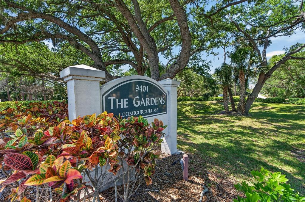 An exterior view of a two-story apartment building with a highlighted second-floor unit — 8039 GARDEN DRIVE UNIT 205, SEMINOLE, FL