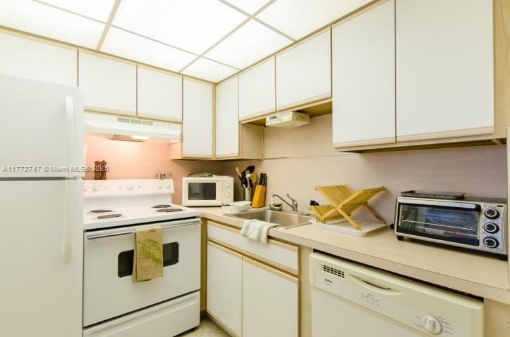 A kitchen with white cabinets, white appliances, and a drop ceiling with recessed lighting — 251 Mansfield F # 251F, Boca Raton FL 33434, BOCA RATON, FL