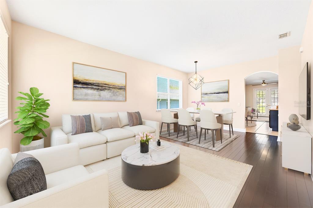 A living and dining room with white furniture, a marble coffee table, and dark flooring — 918 SEBURN ROAD, APOPKA, FL