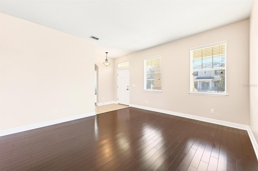 A dining area features a round table with three chairs, a chandelier, and tile flooring — 918 SEBURN ROAD, APOPKA, FL