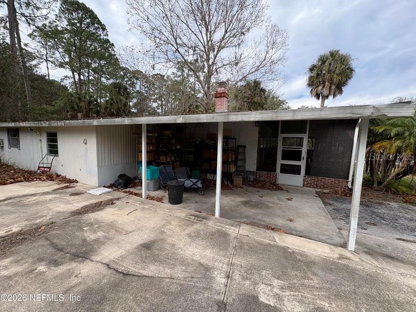 A concrete driveway leads to a covered carport attached to the side of a house — 101 S GERALDO ROAD, EAST PALATKA, FL