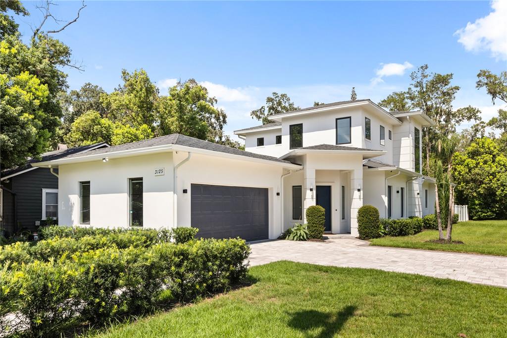 A modern two-story white house with a gray garage and a paved driveway — 3125 S BUMBY AVENUE, ORLANDO, FL