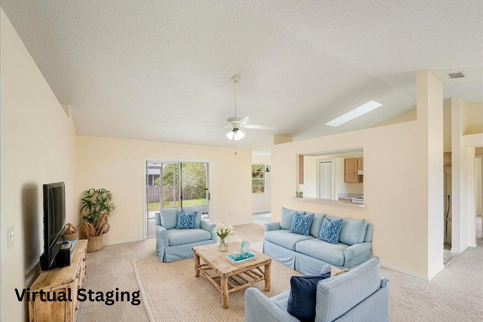 A living room with light walls, carpeted floors, a ceiling fan, and virtual furniture staging — 1545 Barber Street, Sebastian FL 32958, SEBASTIAN, FL