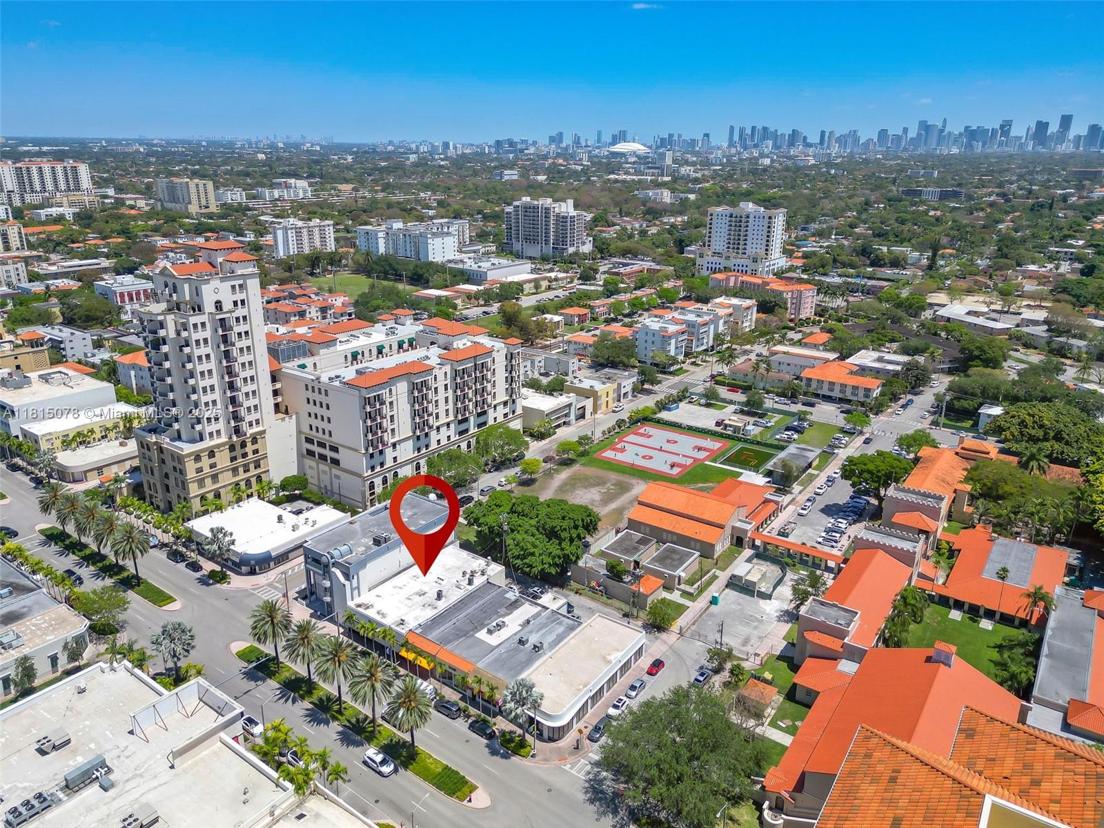 An aerial view shows a commercial building with a red location pin in a city — 1913 Ponce De Leon Blvd, Coral Gables FL 33134, CORAL GABLES, FL