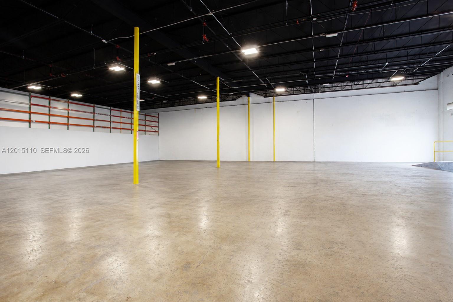 An empty warehouse space features a concrete floor, white walls, and exposed black ceiling — 2290 W 8th Ave, Hialeah FL 33010, HIALEAH, FL