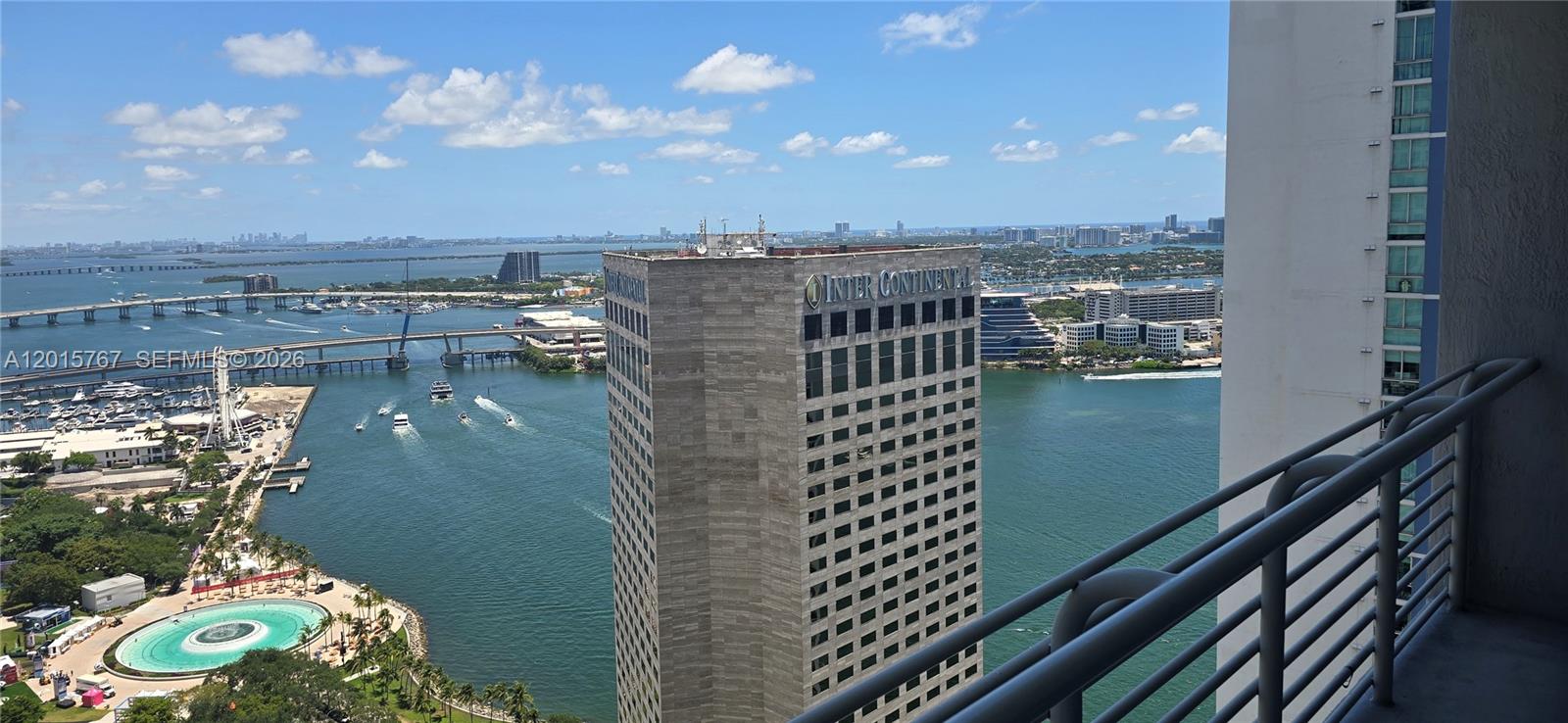 A high-angle view from a balcony overlooking a bay, a hotel, and a bridge — 325 S Biscayne Blvd # 4016, Miami FL 33131, MIAMI, FL