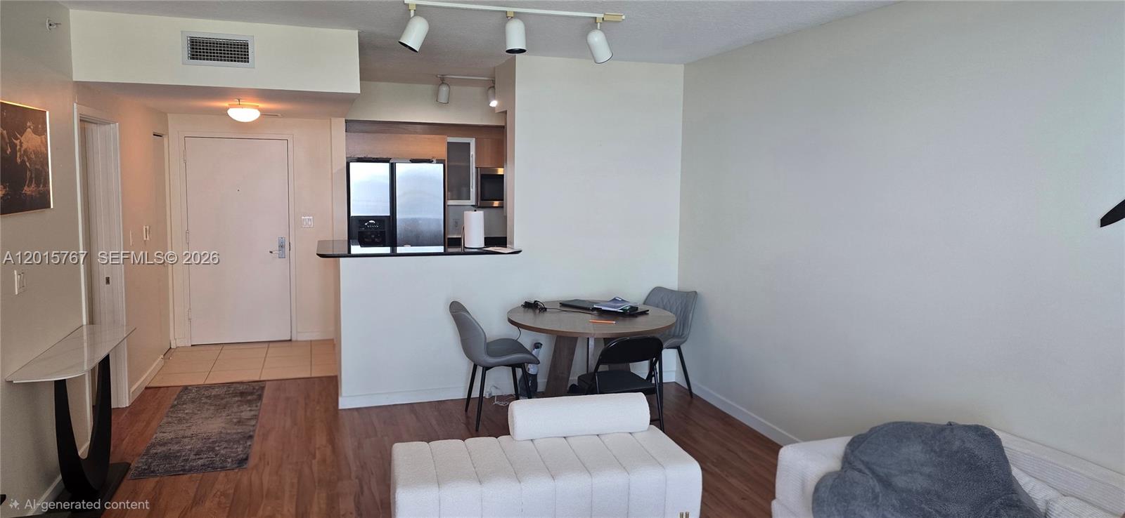 This living area features a dining table, kitchen pass-through, and light-colored wood flooring — 325 S Biscayne Blvd # 4016, Miami FL 33131, MIAMI, FL