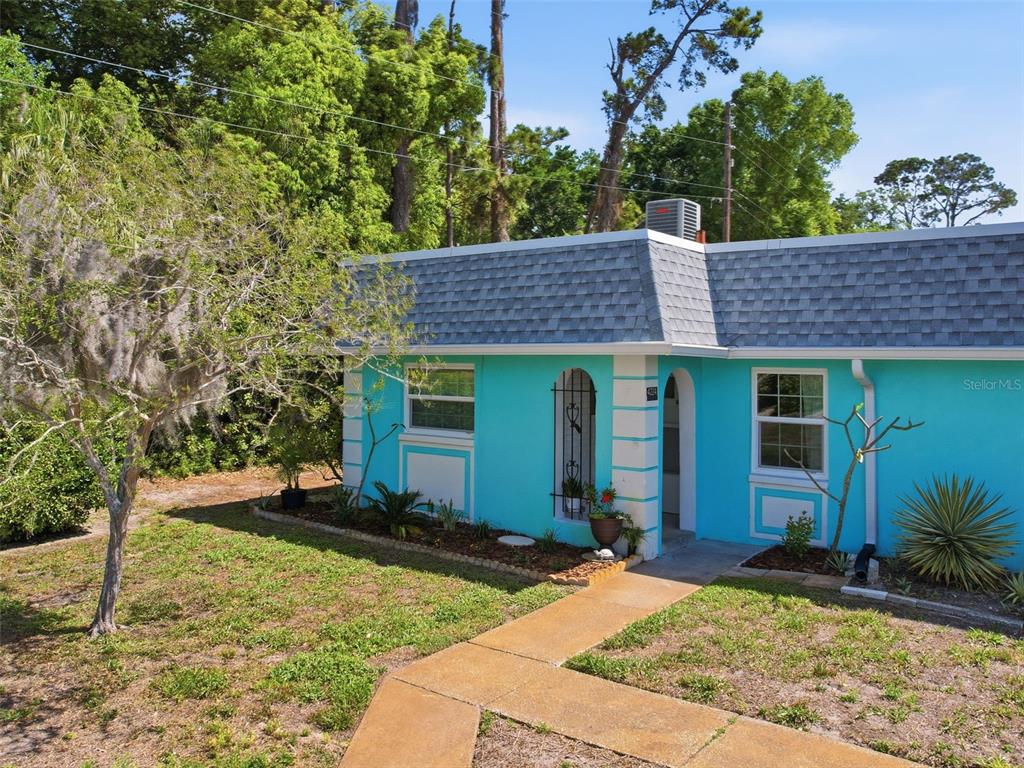 A bright turquoise house features a gray mansard roof and a concrete walkway — 4224 TERRAPIN PLACE UNIT 4224, NEW PORT RICHEY, FL