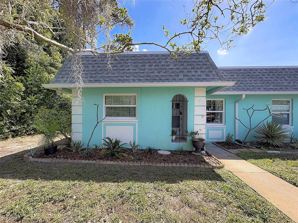 A turquoise single-story residential building with a gray shingled roof and a front walkway — 4224 TERRAPIN PLACE UNIT 4224, NEW PORT RICHEY, FL