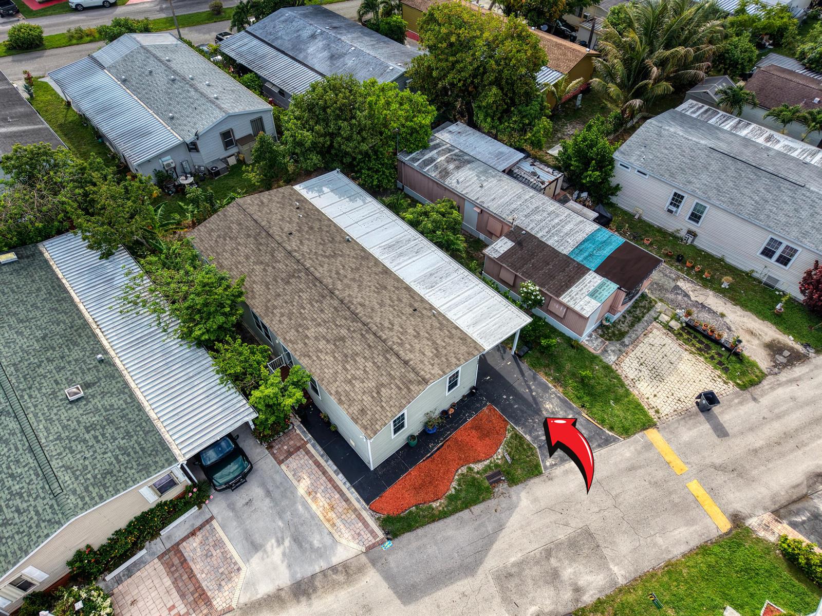 An aerial view shows a residential street with several manufactured homes and paved driveways — 4625 Jill Place, FL 33463, FL