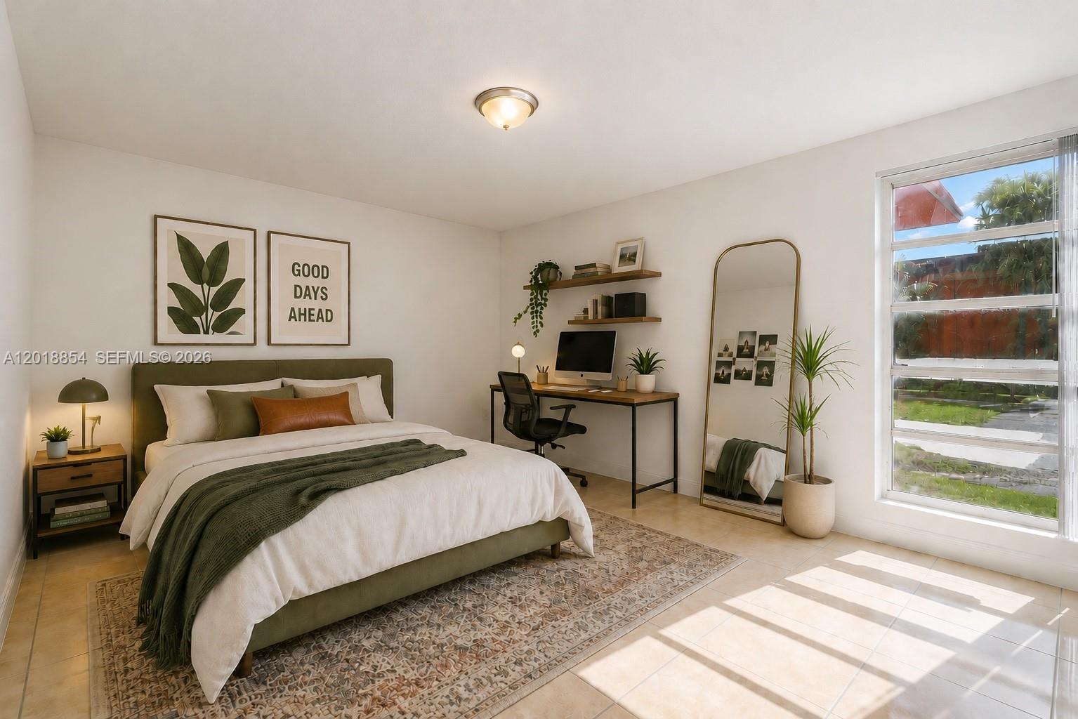 A bedroom features a green bed, a desk with shelving, a floor mirror, and tile flooring — 9483 SW 76 St # N1, Miami FL 33173, MIAMI, FL