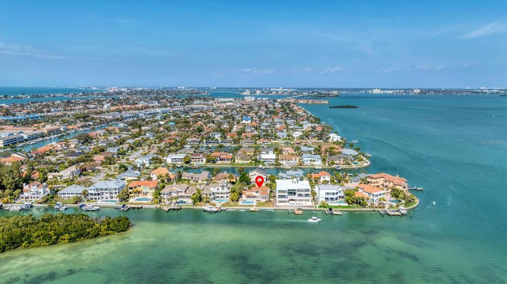 An aerial view shows a waterfront house with a pool on a residential island — 120 SANDS POINT DRIVE, TIERRA VERDE, FL