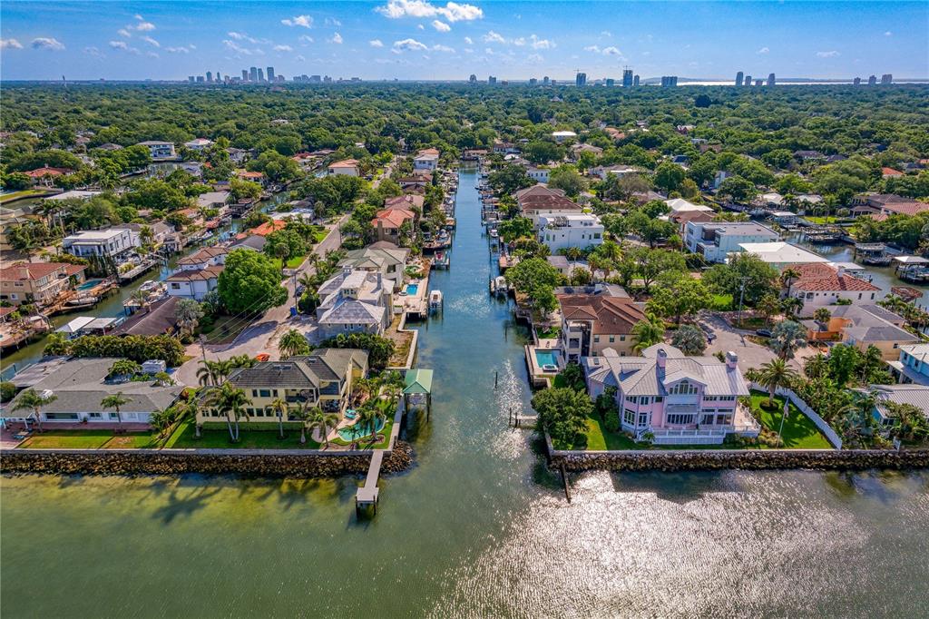 An aerial view of a canal-front residential neighborhood with houses, swimming pools, and docks — 4815 W SAN RAFAEL STREET, TAMPA, FL