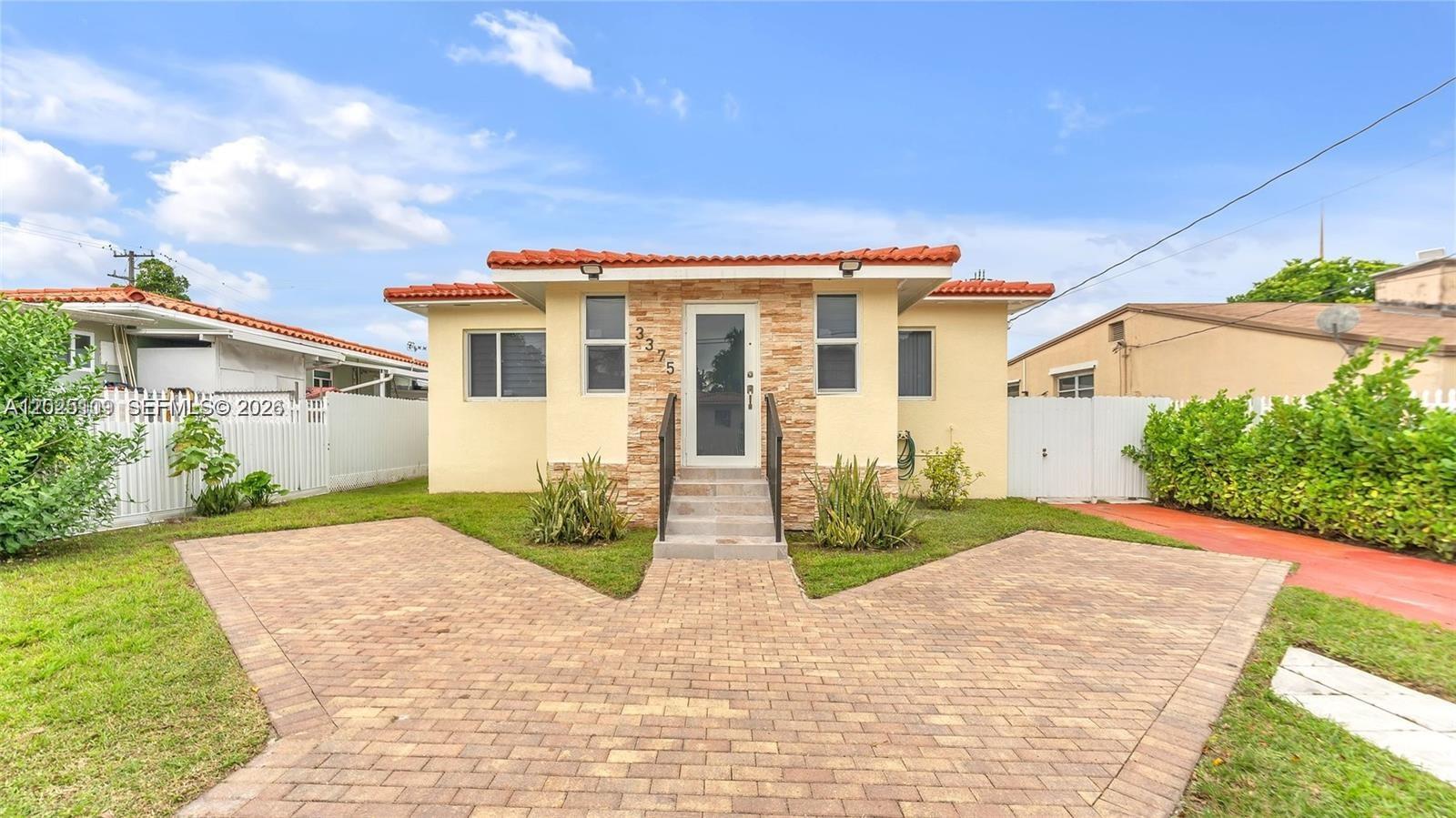 A single-story house with a tiled roof, stone facade, and a paved brick driveway — 3375 SW 1st St, Miami FL 33135, MIAMI, FL