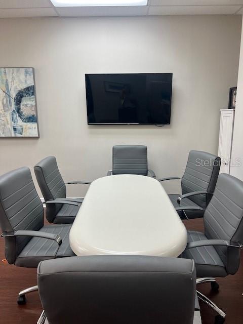 A conference room features a white oval table surrounded by six gray office chairs — 16540 POINTE VILLAGE DRIVE UNIT 206, LUTZ, FL