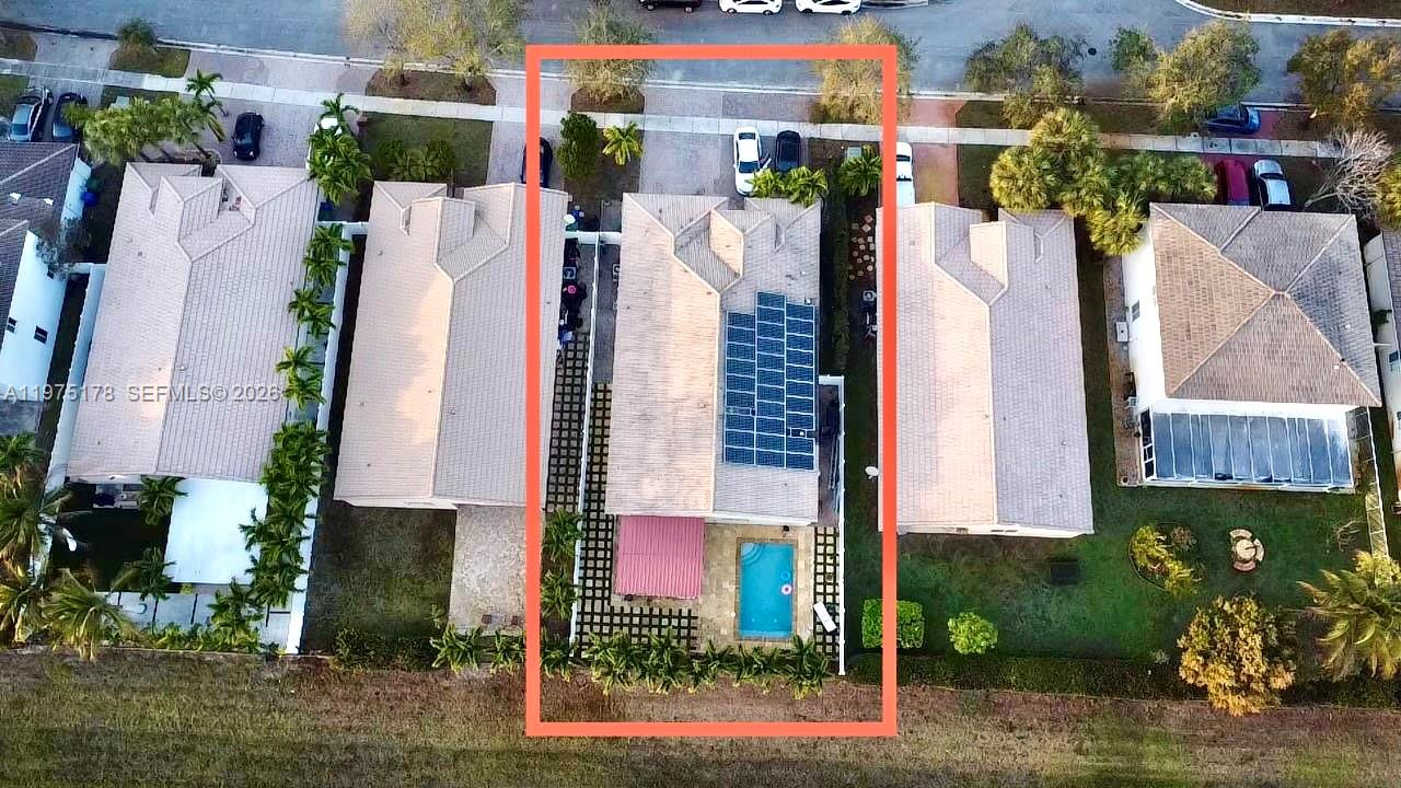 An aerial view shows a residential house with a solar panel array and a pool — 12718 SW 47th St, Miramar FL 33027, MIRAMAR, FL
