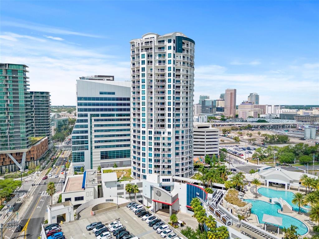 An aerial view shows a tall residential tower, adjacent office buildings, and a swimming pool — 449 S 12TH STREET UNIT 1903, TAMPA, FL