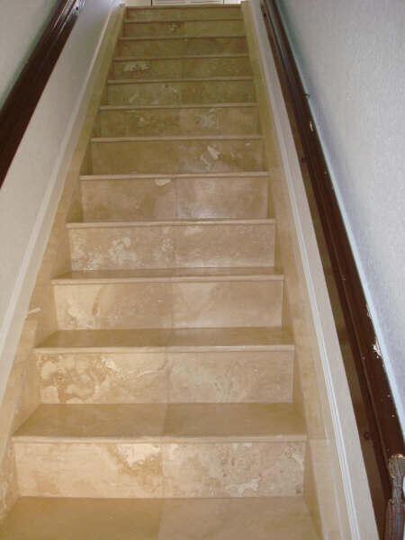 A straight staircase features beige stone tile treads and risers with dark wooden handrails — 229 E 3rd Street # 2, Hialeah FL 33010, HIALEAH, FL