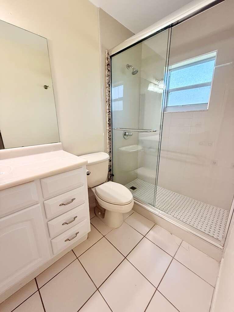 A bathroom with a white vanity, a toilet, and a glass-enclosed walk-in shower — 1918 Palmland Drive # 2, Boynton Beach FL 33436, BOYNTON BEACH, FL