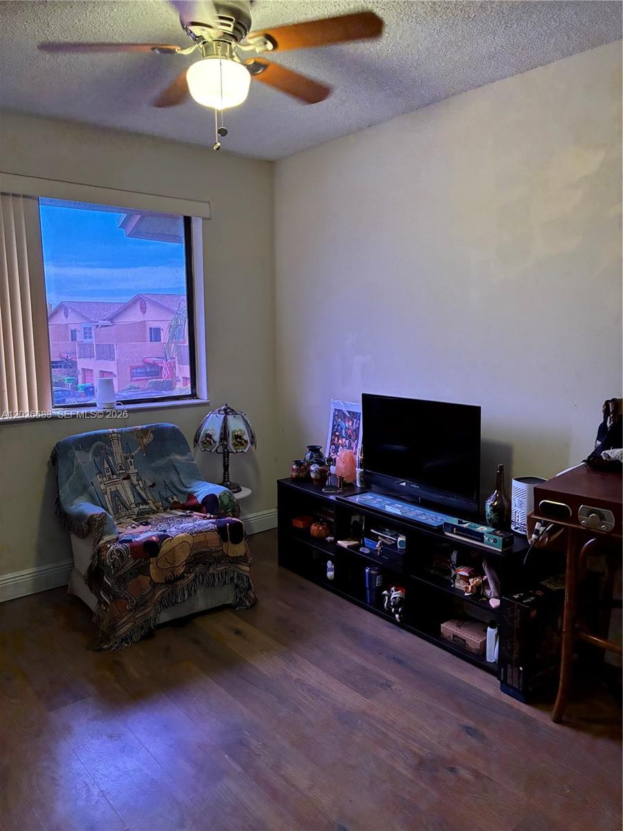 A room features a ceiling fan, a window with exterior views, a chair, and a television — 2828 NW 80th Ave, Sunrise FL 33322, SUNRISE, FL