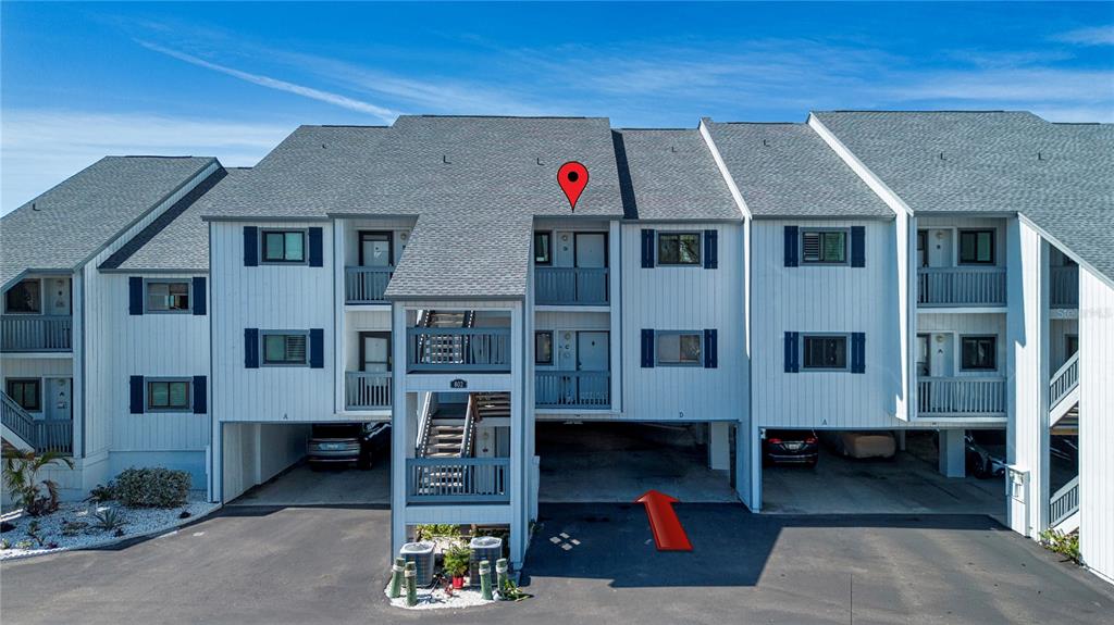 Exterior view of a multi-story apartment building with covered parking and an outdoor staircase — 802 BAHIA DEL SOL DRIVE UNIT 6, RUSKIN, FL