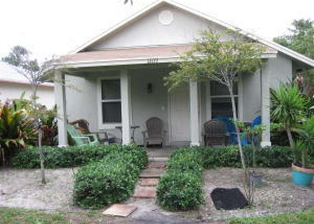 A single-story house with a covered front porch, a stone walkway, and landscaped bushes — 1209 S DIXIE HIGHWAY, DELRAY BEACH, FL