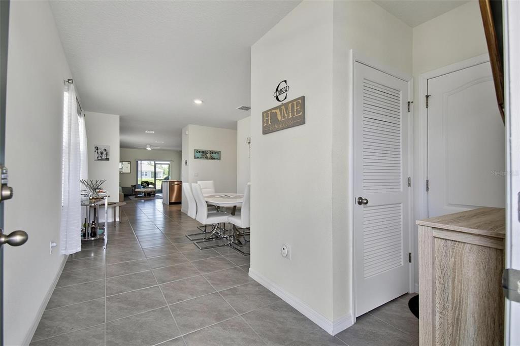 An interior view shows a tiled entryway leading to a dining area and living space — 1337 CORK DRIVE, ORMOND BEACH, FL