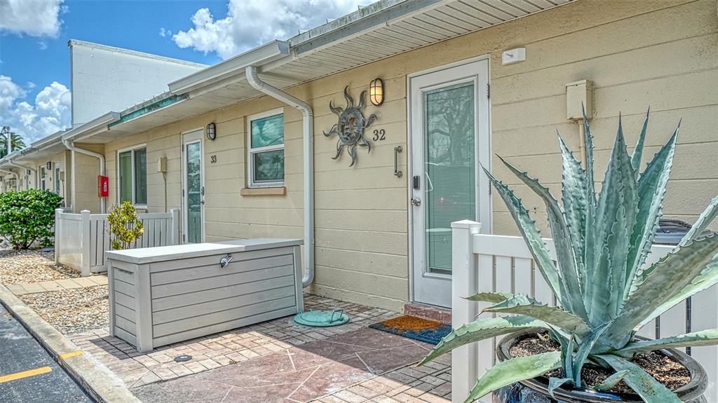 Exterior view of a single-story building with two numbered doors and a large potted agave — 5830 MIDNIGHT PASS ROAD UNIT 32, SARASOTA, FL