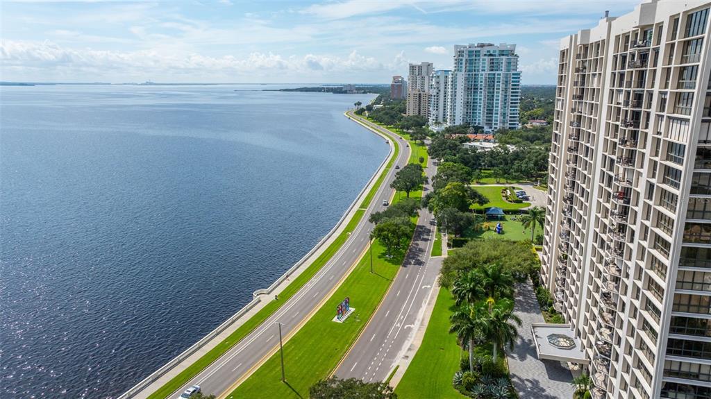 An aerial view shows a coastal road running alongside a large body of water — 3301 BAYSHORE BOULEVARD UNIT 1510A, TAMPA, FL