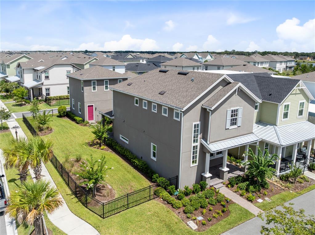 An aerial view shows a two-story suburban house with a fenced yard and driveway — 10205 PEARSON AVENUE, ORLANDO, FL