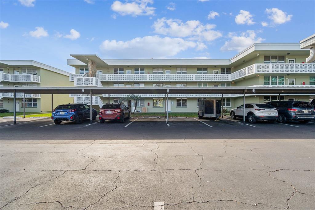 A multi-story apartment building with a covered parking area in front — 4885 1ST STREET NE UNIT 203, ST PETERSBURG, FL