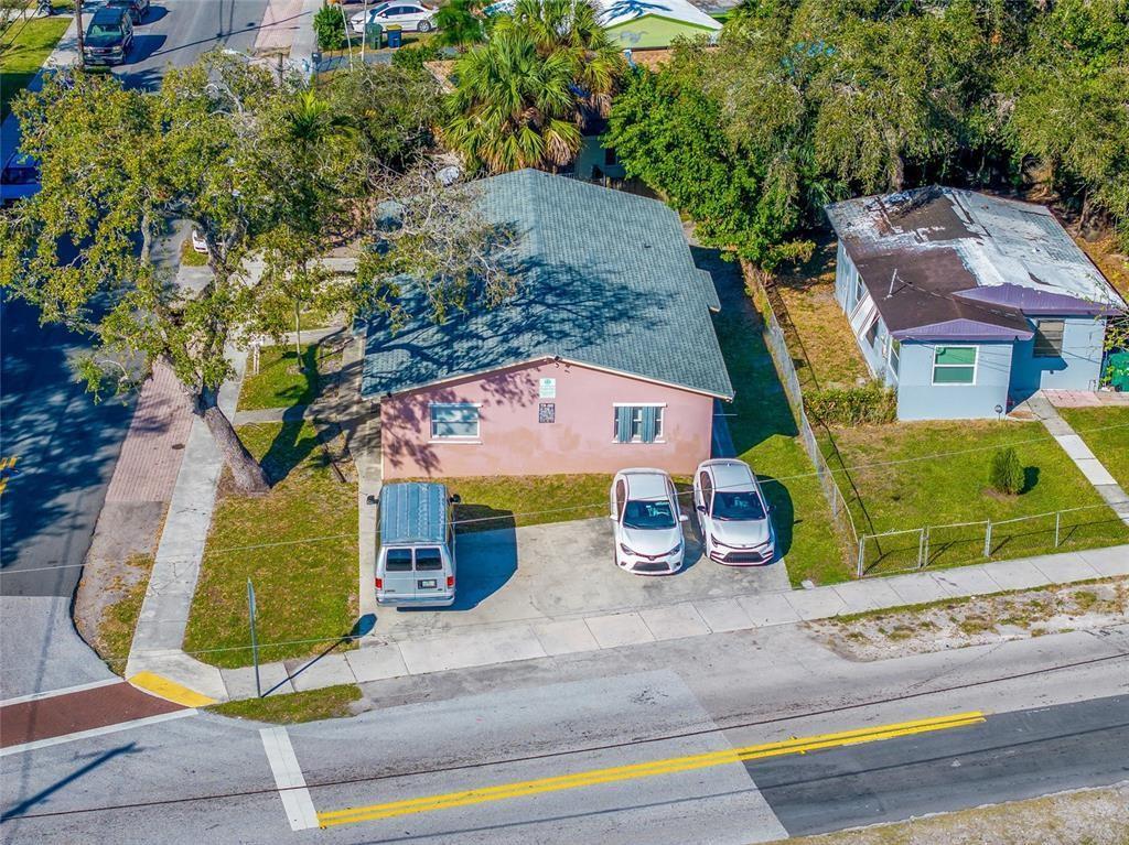 An aerial view shows a pink house with a gray roof and three parked vehicles — 6 SW 7th Avenue, Dania Beach FL 33004, DANIA BEACH, FL