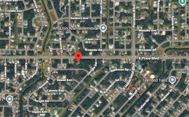 This is a satellite map view of a residential neighborhood with a red location pin — E PRICE BOULEVARD, NORTH PORT, FL