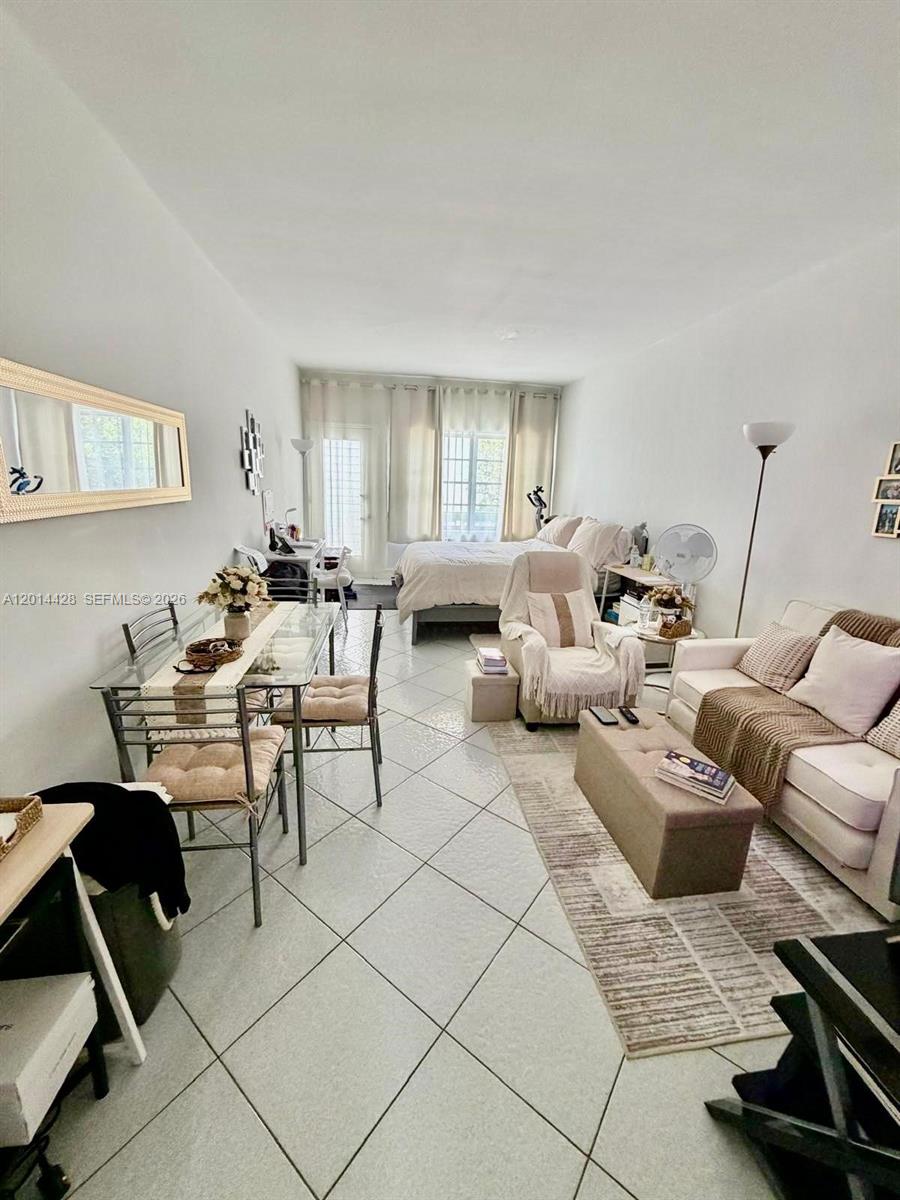 This studio apartment features a dining area, a living space, and a bed near windows — 6490 Collins Ave # 14, Miami Beach FL 33141, MIAMI BEACH, FL