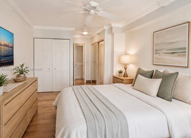 A bedroom features a bed with neutral bedding, a wooden dresser, and a ceiling fan — 4505 S Ocean Blvd # 502, Highland Beach FL 33487, HIGHLAND BEACH, FL
