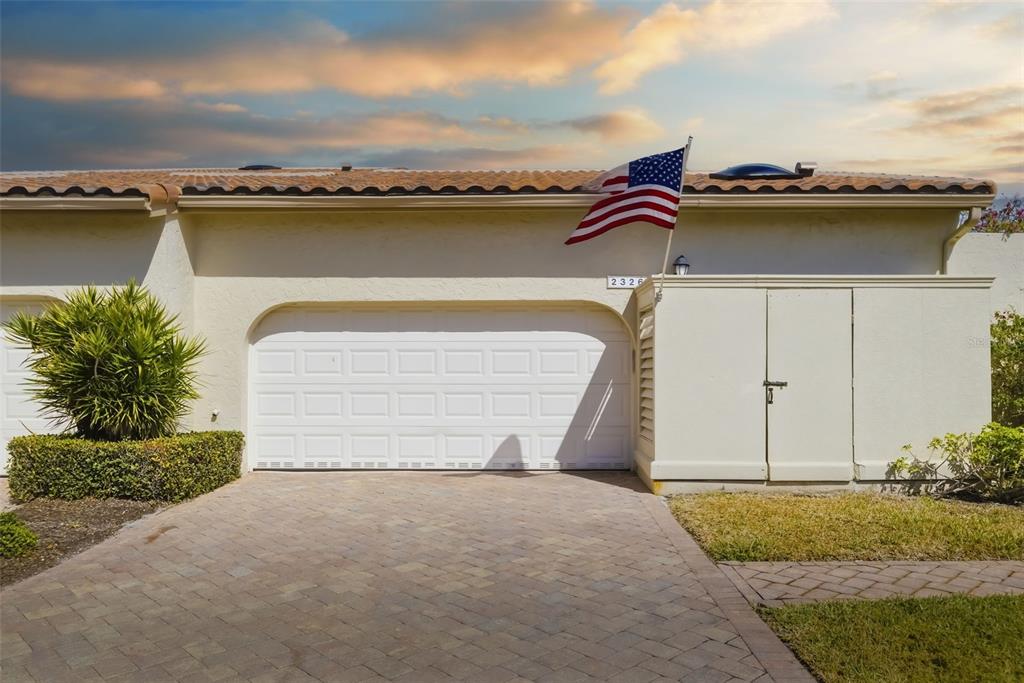 An aerial view of a residential villa with a tiled roof and two-car garage — 2326 HARBOUR OAKS DRIVE, LONGBOAT KEY, FL