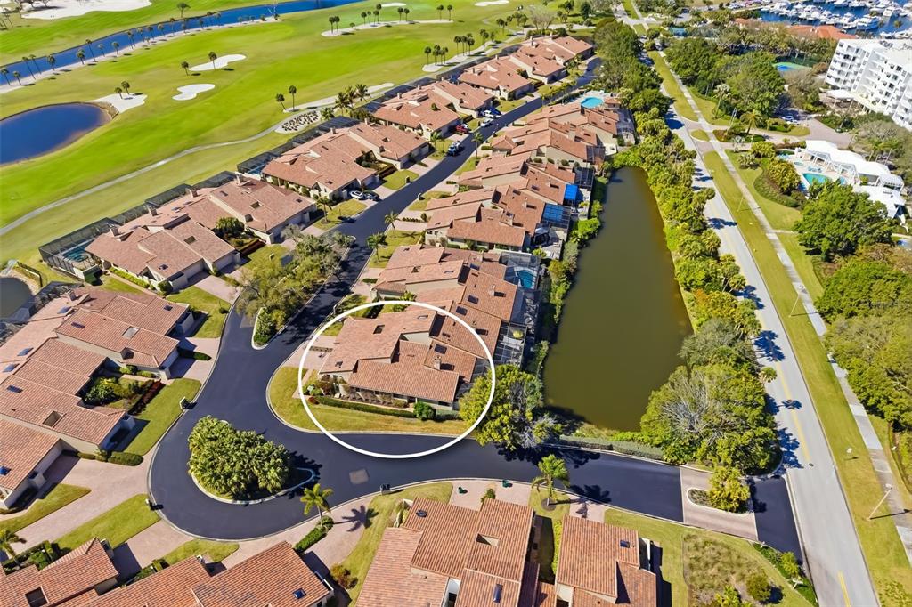 A single-story house with a tiled roof, a manicured hedge, and a front lawn — 2326 HARBOUR OAKS DRIVE, LONGBOAT KEY, FL
