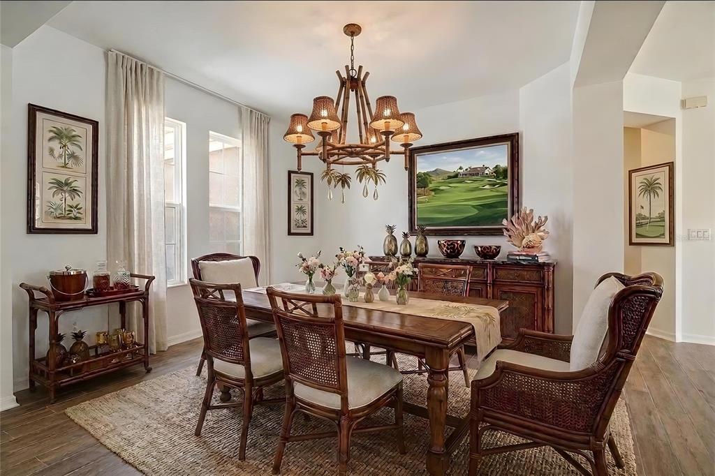 A dining room features a wooden table, rattan chairs, a bamboo chandelier, and tropical decor — 5108 JENNINGS TRAIL, BROOKSVILLE, FL