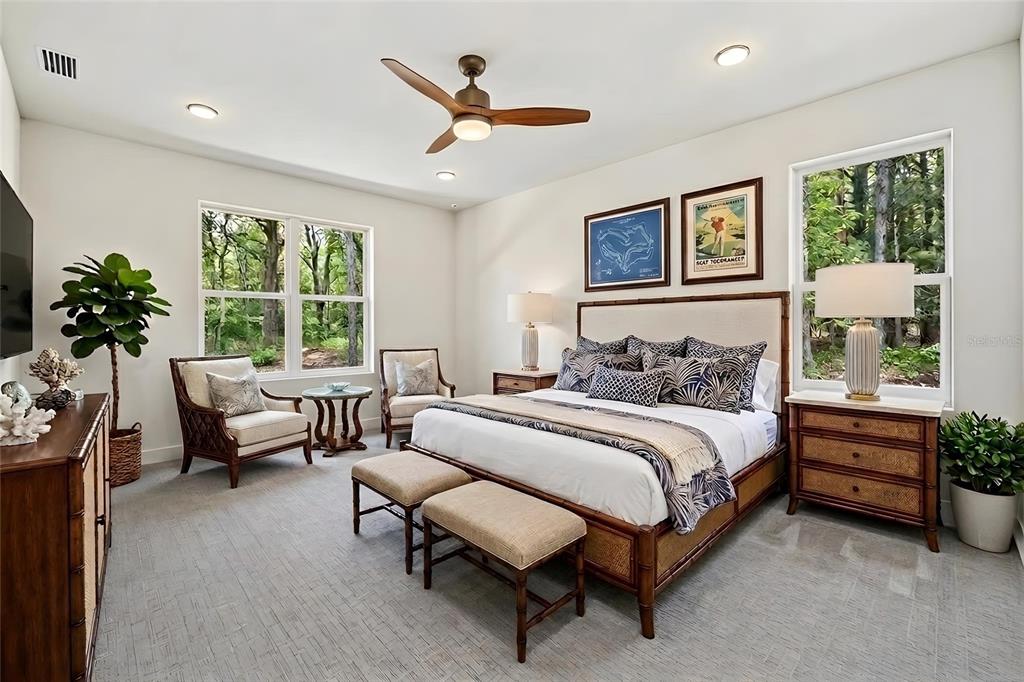 A bedroom features a king bed, two armchairs, a ceiling fan, and large windows — 5108 JENNINGS TRAIL, BROOKSVILLE, FL